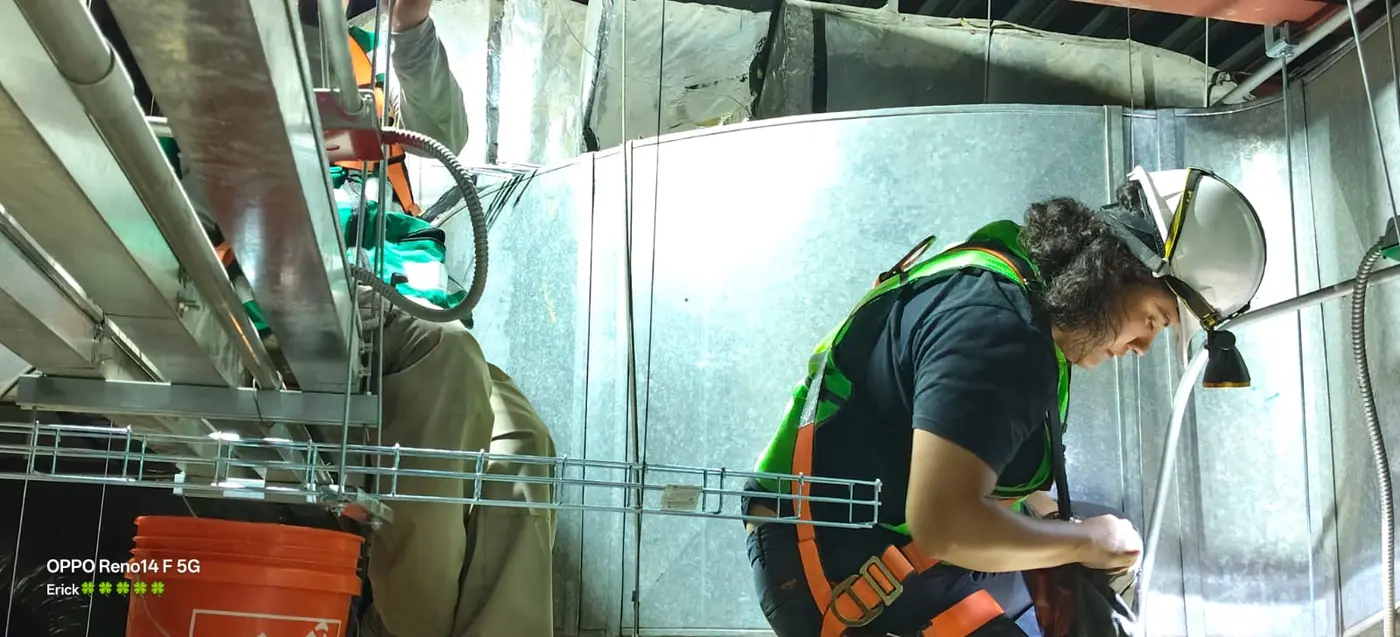 Personal técnico instalando infraestructura en altura